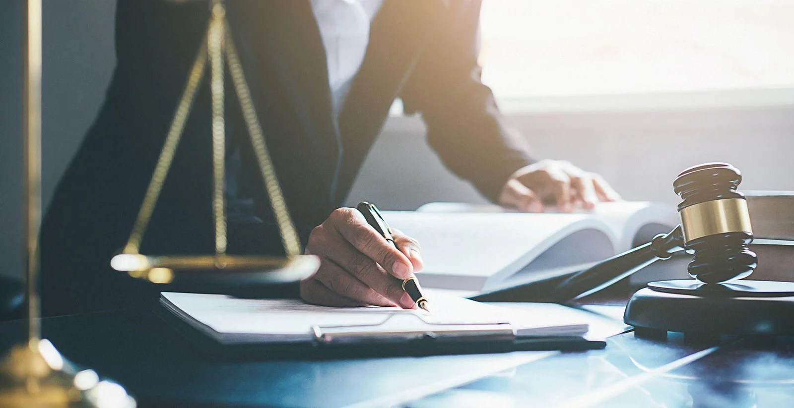 Person reviewing legal documents at a desk