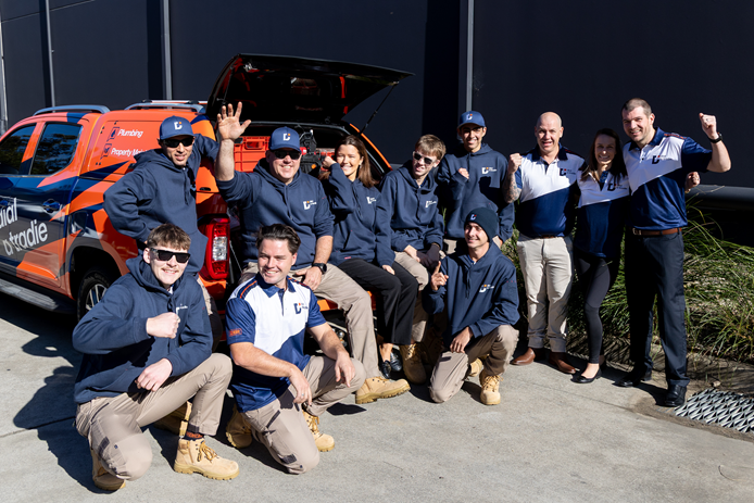 Dial A Tradie Central Coast family-owned tradie team in front of branded van