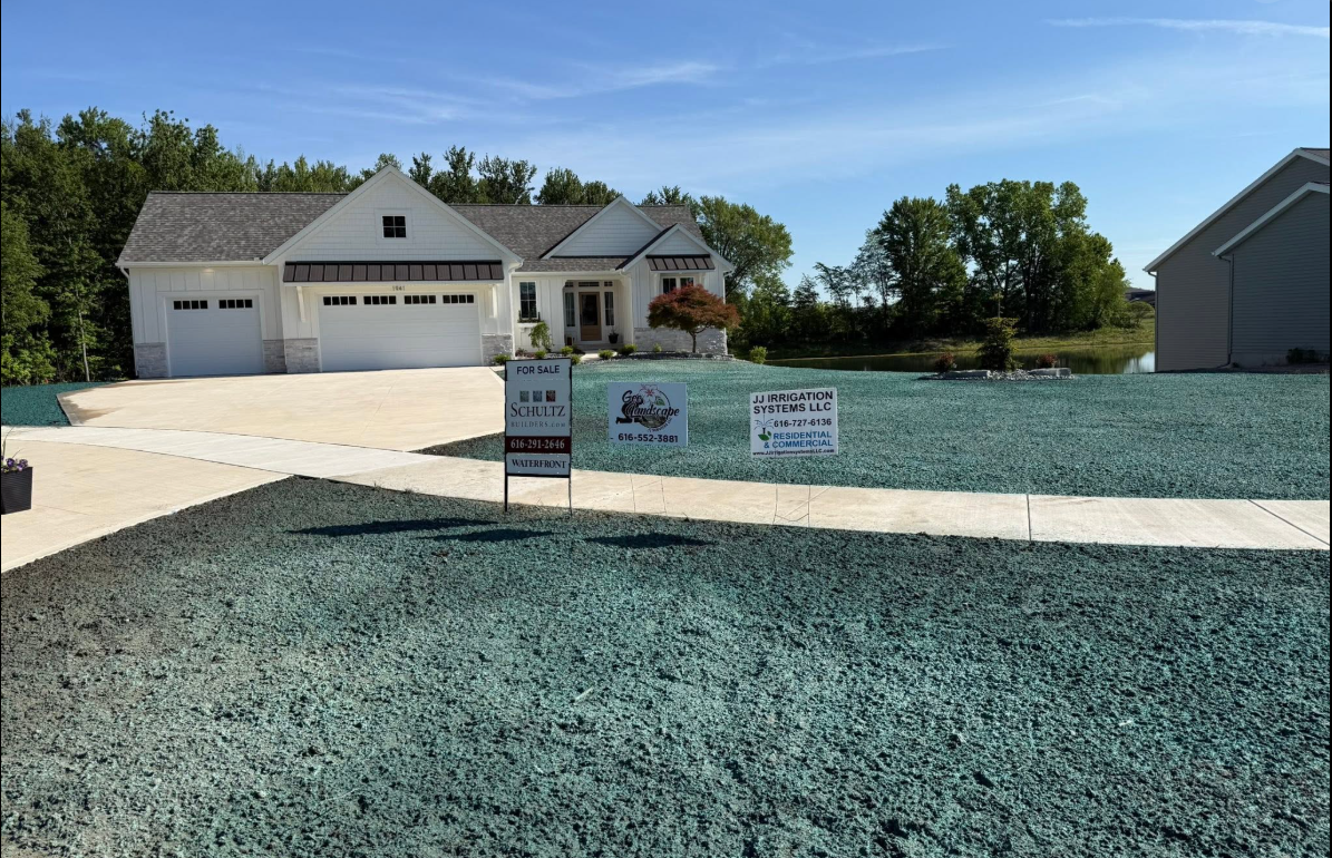 Hydroseeded lawn area beside landscape beds in a West Michigan yard