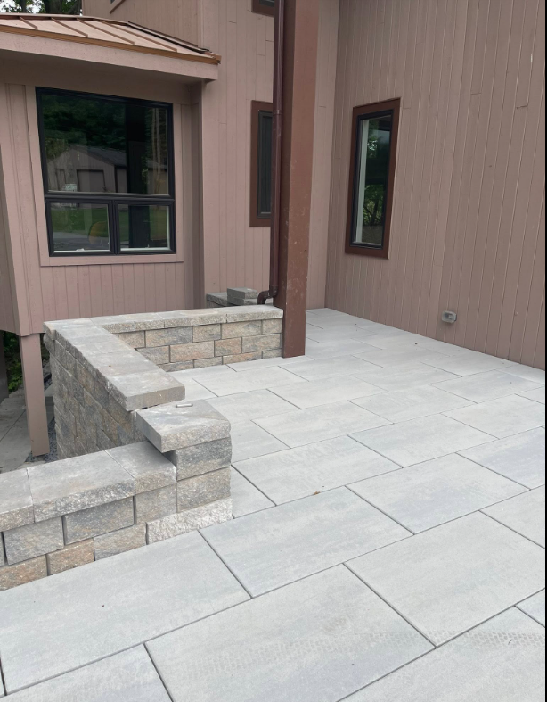 West Michigan residential landscaping with patio, walkway, and landscape beds