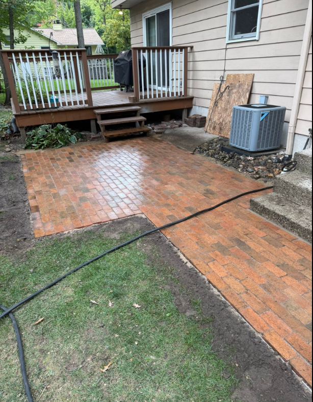 Patio with surrounding landscape features in a West Michigan yard