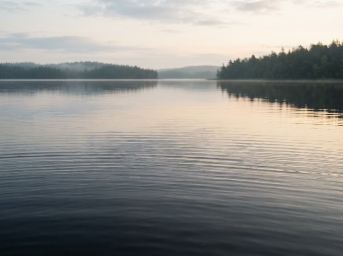 Calm water surface with gentle ripples in soft morning light