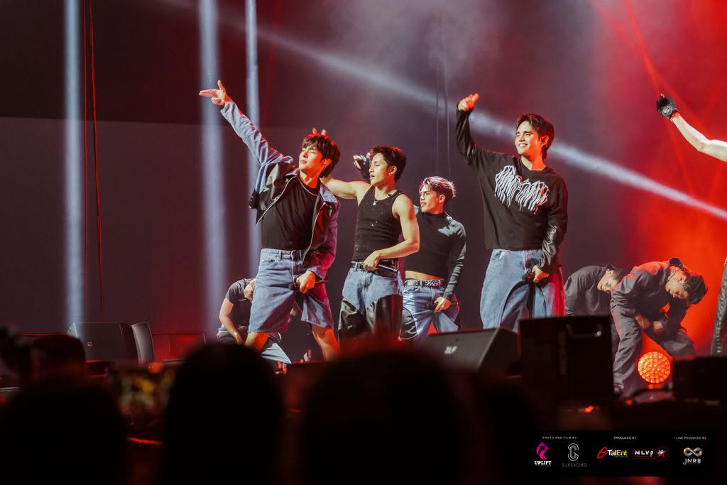 High-energy choreography with SB19 commanding the stage in denim street style under vibrant red stage washes.