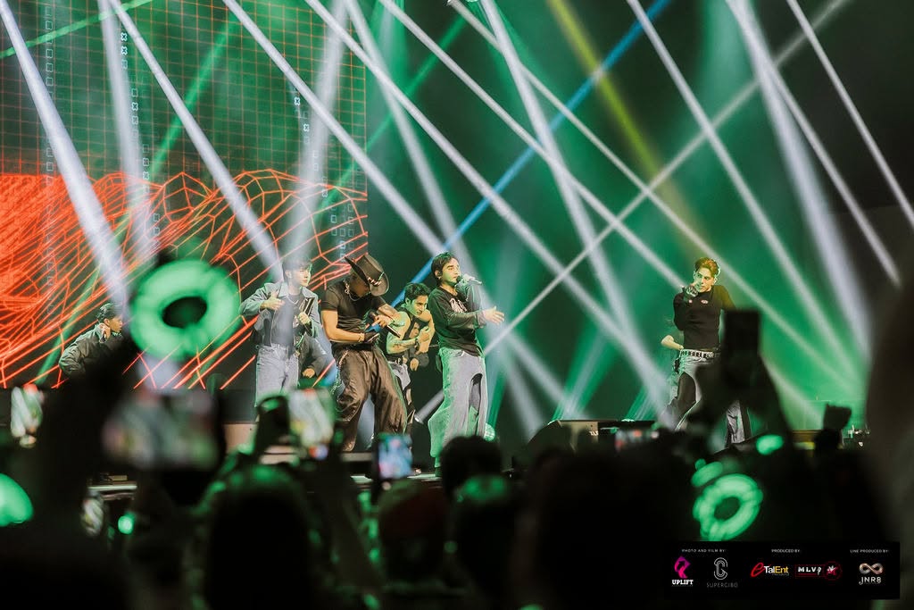 SB19 lighting up the stage in full choreography under striking green beams during their 2025 Oceania tour.