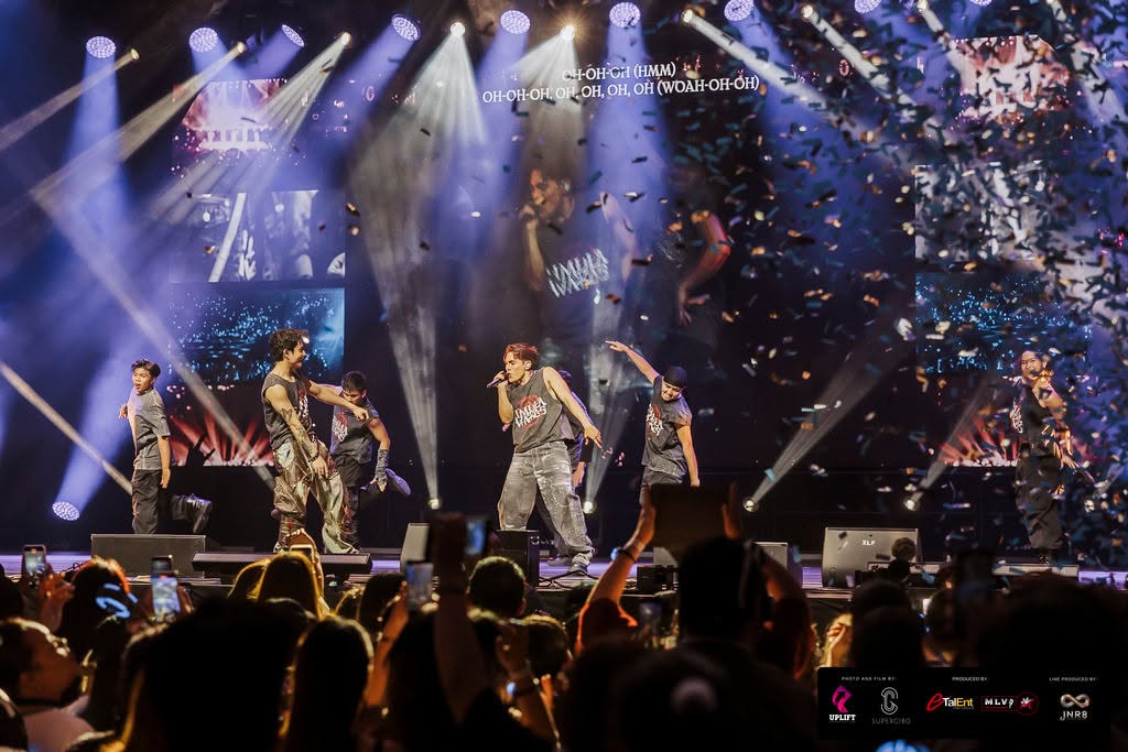 SB19 electrifying the arena amidst falling confetti, powerful spotlights and a singing ocean of fans.