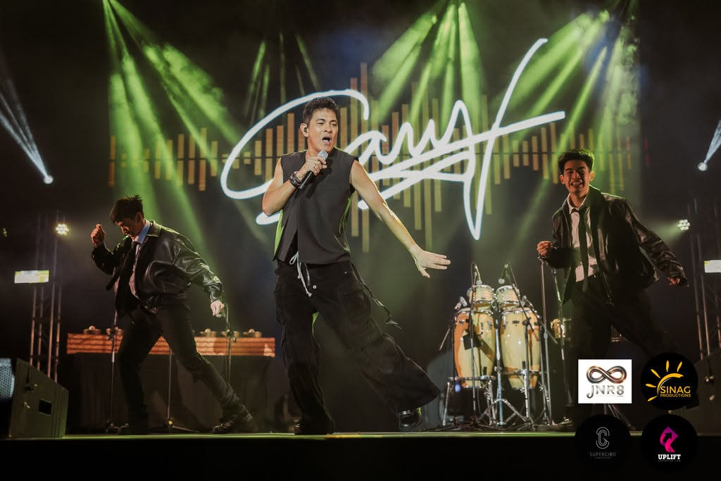 Gary V delivering trademark high energy mid-choreography with backup dancers on stage under radiant green spotlights during Pure Energy Down Under 2025.