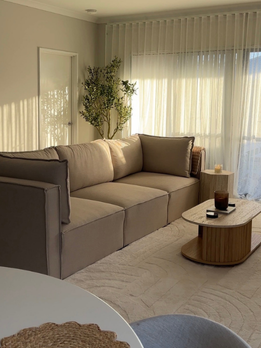 Lounge room with neutral linen sofa and warm natural light