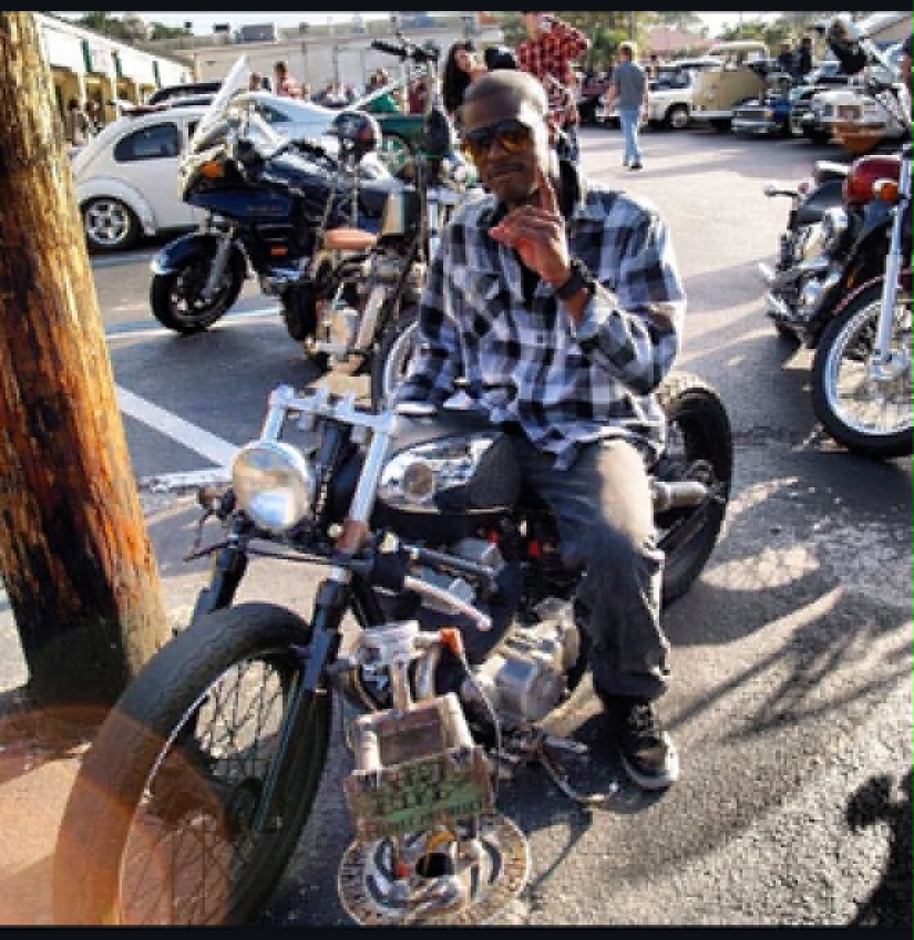 Rider on finished custom bobber motorcycle at bike meet showcasing Marlito craftsmanship