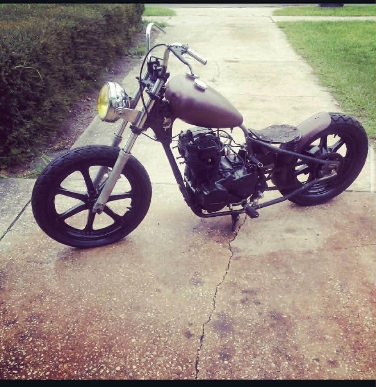 Custom bobber motorcycle with matte brown tank and yellow headlight built by Marlito Motorcycles
