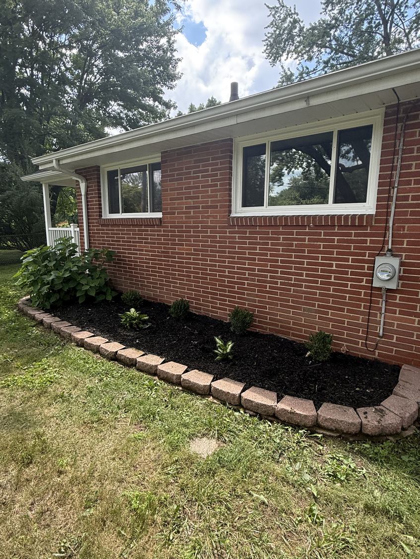 Mulching & Mulch Installation after — clean, mulched beds with crisp stone border definition