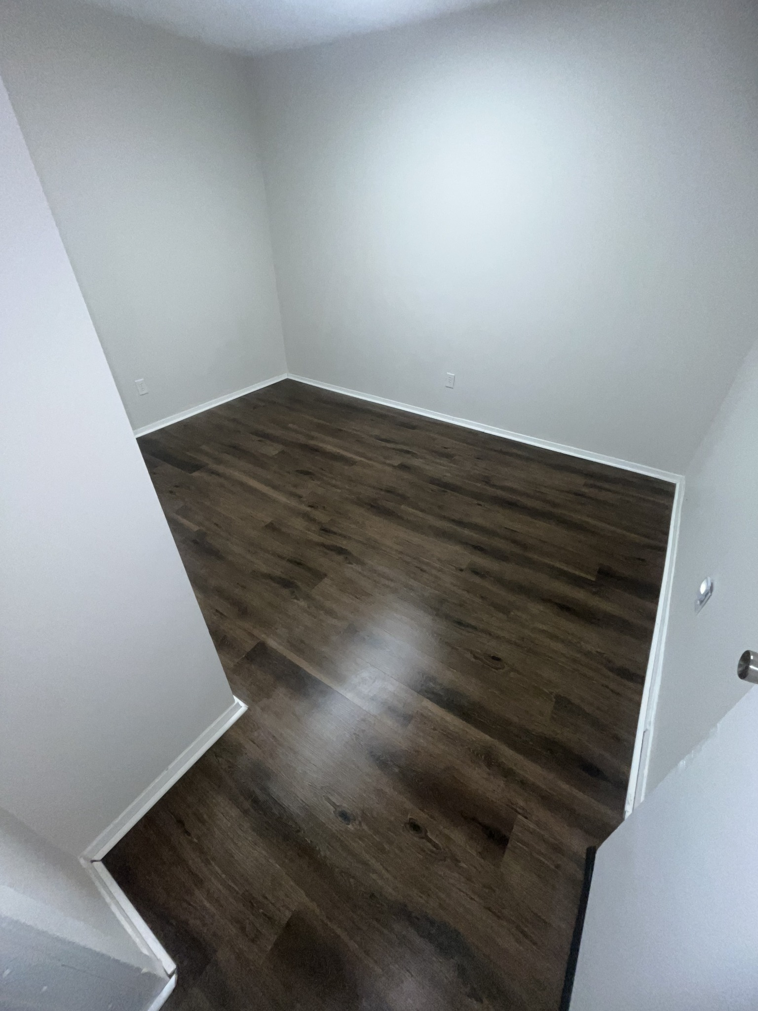 Spotless gleaming hardwood floor after professional move-out cleaning