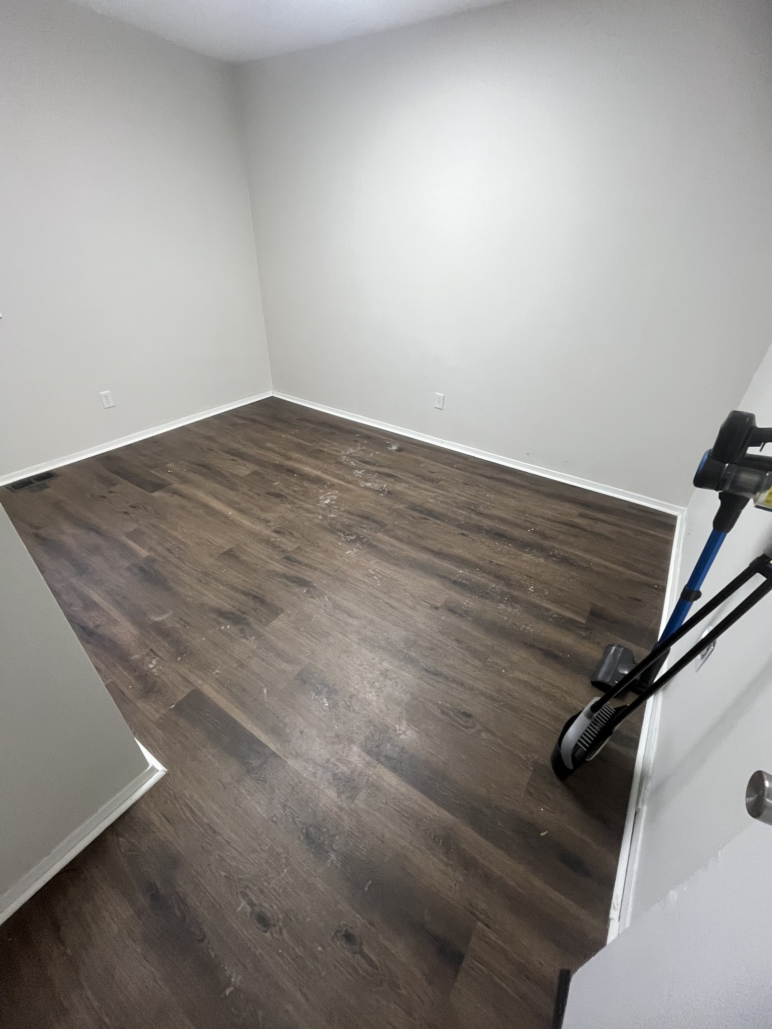 Vacated room floor covered in drywall dust and debris before move-out cleaning