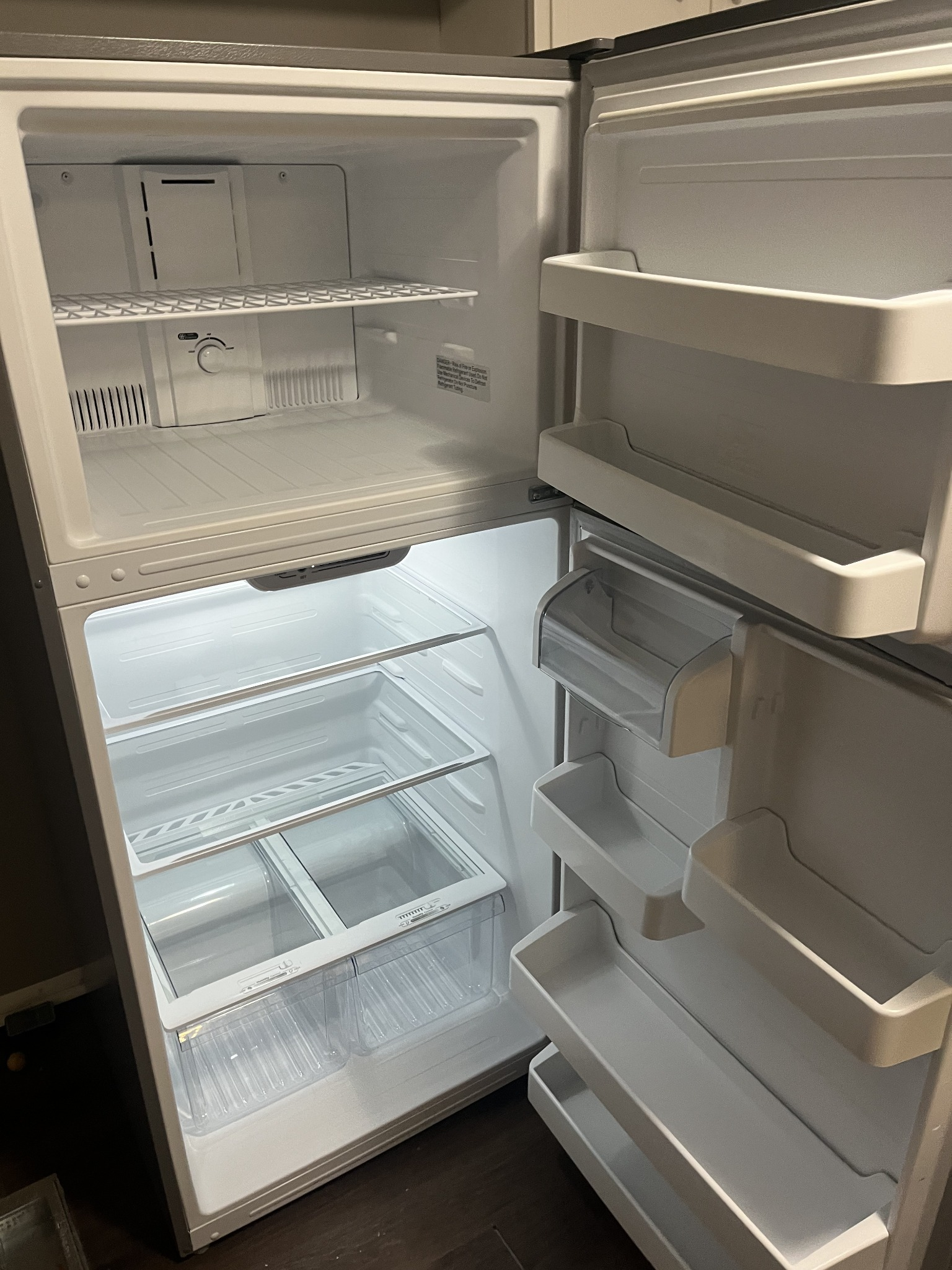 Spotlessly cleaned and sanitized refrigerator interior with clean shelves and crisper drawers