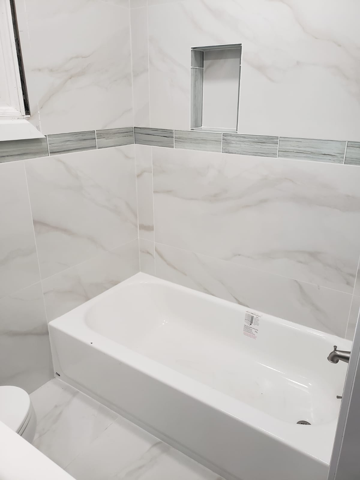 Marble-tile bathroom renovation by Dougy Construction