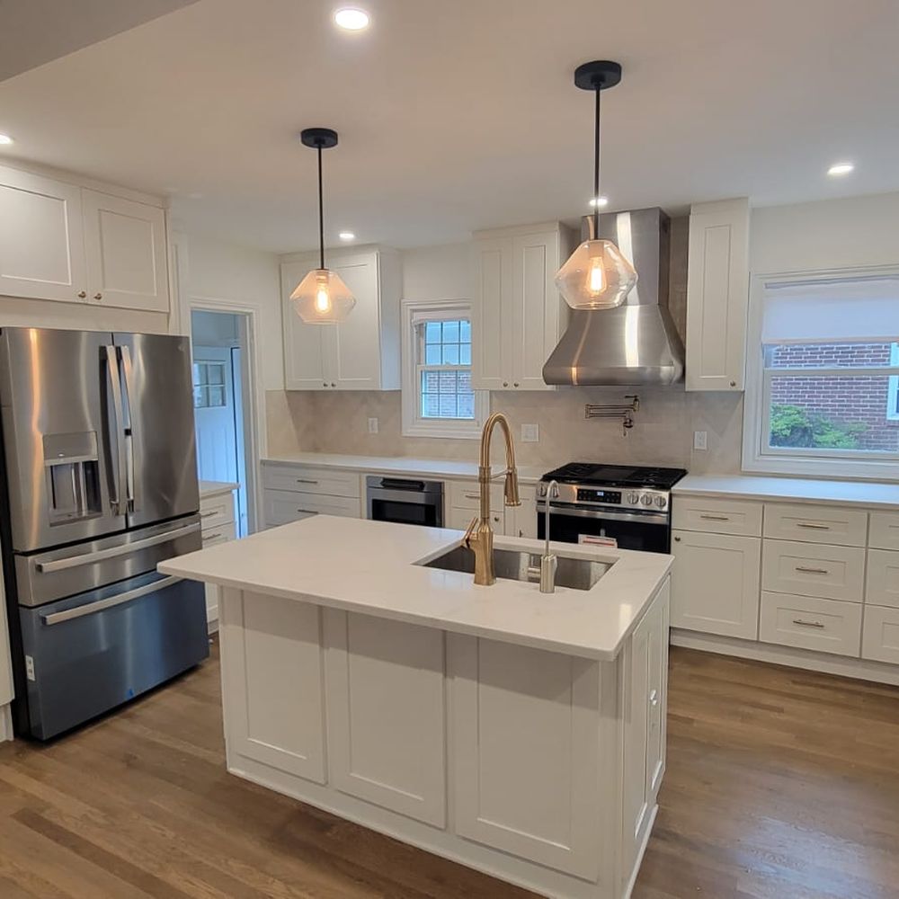 Custom open kitchen renovation with white shaker cabinets and quartz island in Valley Stream