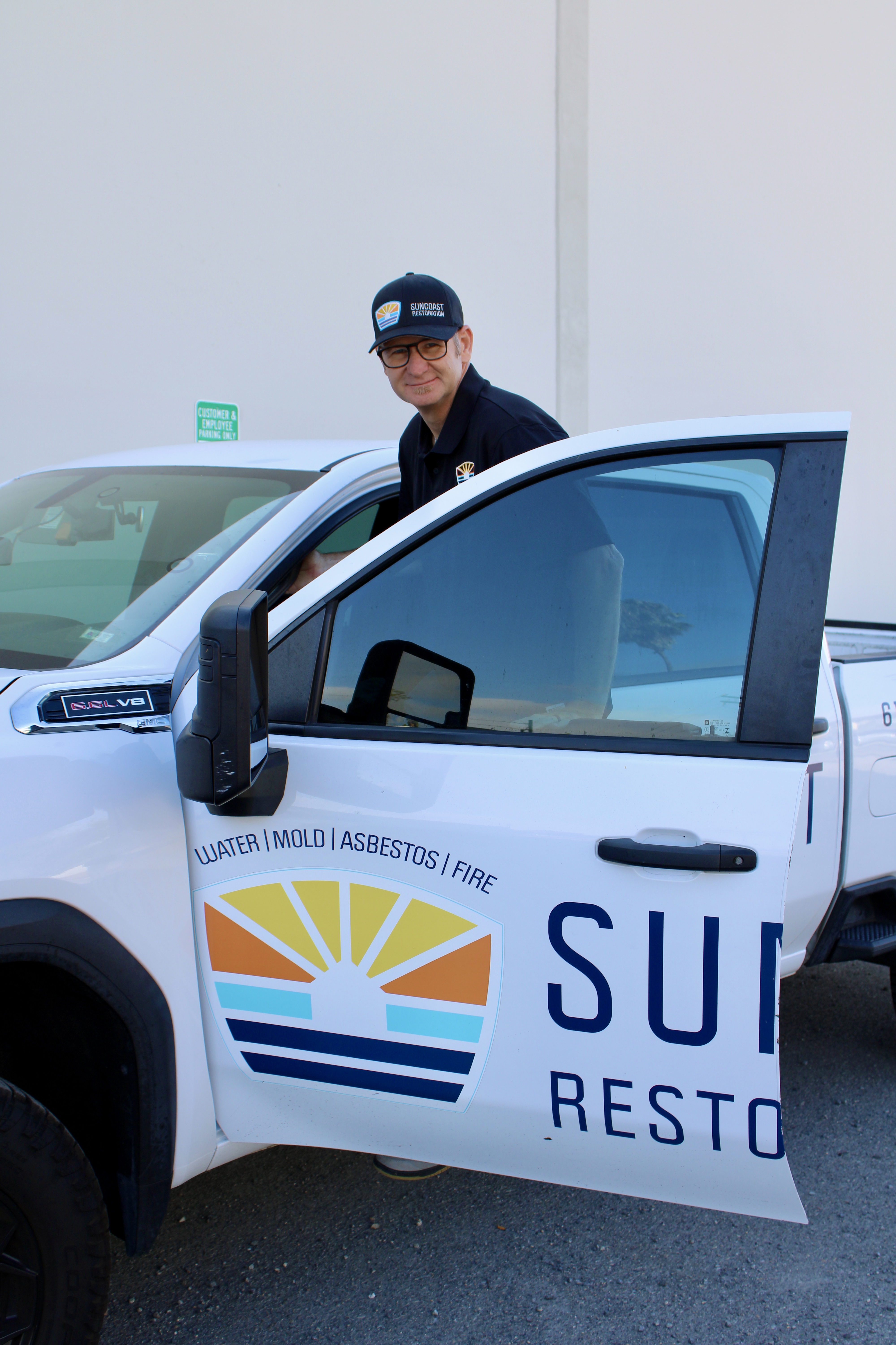 SunCoast Restoration technician with branded restoration truck