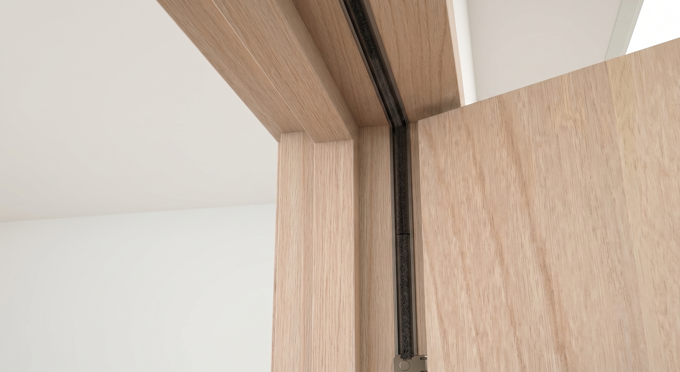 Black intumescent seal installed in the rebate of a timber fire door frame