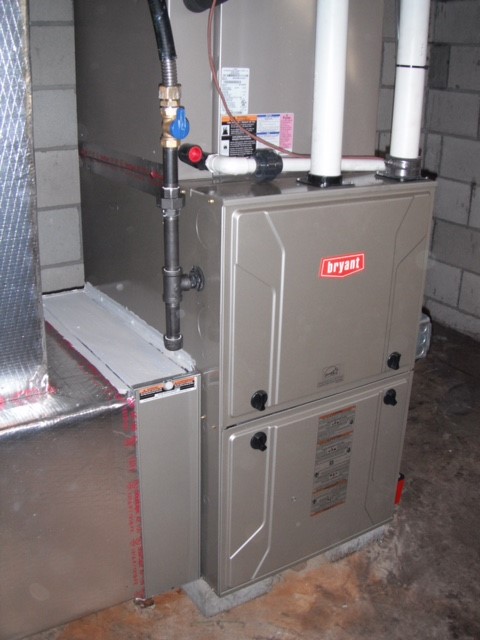 High-efficiency gas furnace with media air filter in a clean basement