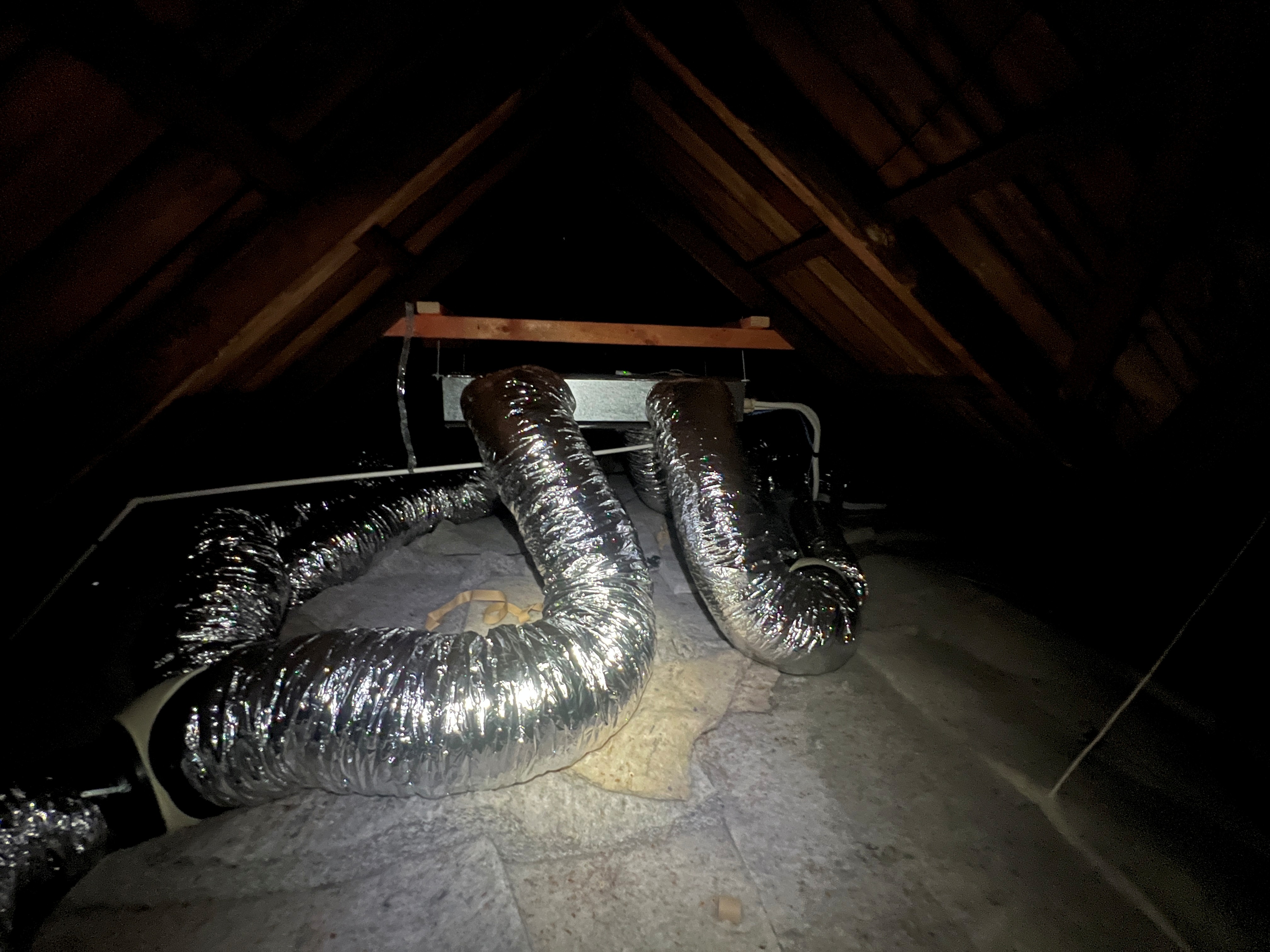 Insulated ductwork and ducted indoor unit installed in the villa's roof space.