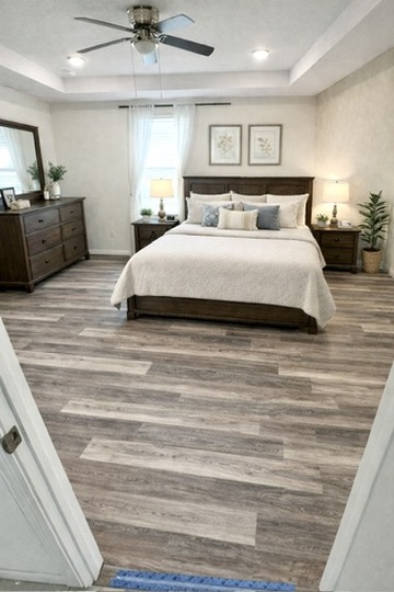 Multi-tone luxury vinyl plank flooring installed in a Lakeland master bedroom suite
