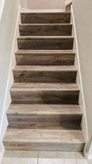 Full plank wrap staircase with matching rustic oak treads and risers installed by Genesis Flooring in Polk County FL