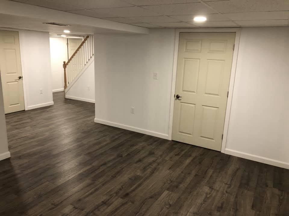 Basement finishing by Handy Lou's — in-progress with vapor barrier and support posts