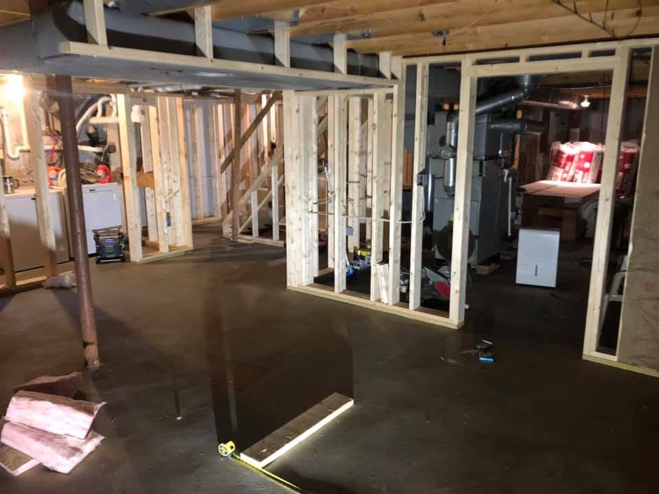 Basement finishing by Handy Lou's — after with light blue walls and white painted columns