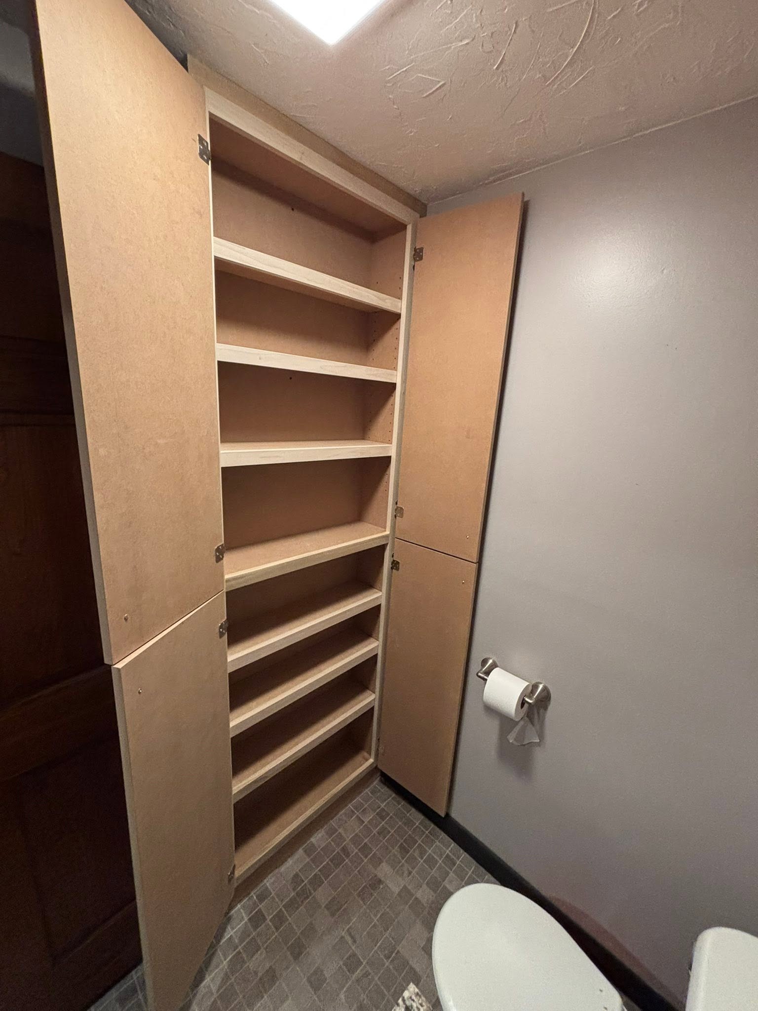 Custom woodwork by Handy Lou's — before — built-in shelving under construction, raw wood frame