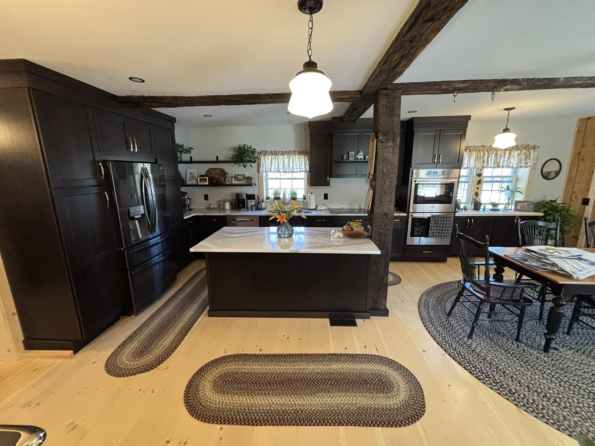 Kitchen remodel by Handy Lou's — dark gray cabinets with exposed rustic beams and farmhouse island