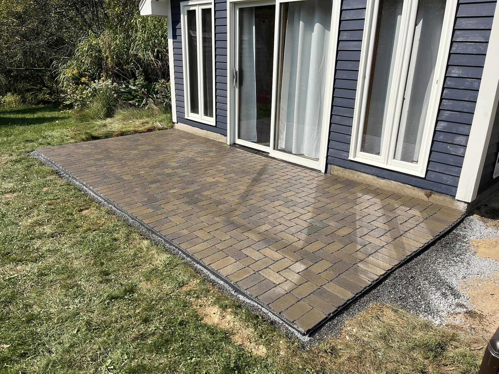 Paver or walkway project by Handy Lou's — paver patio with navy blue house