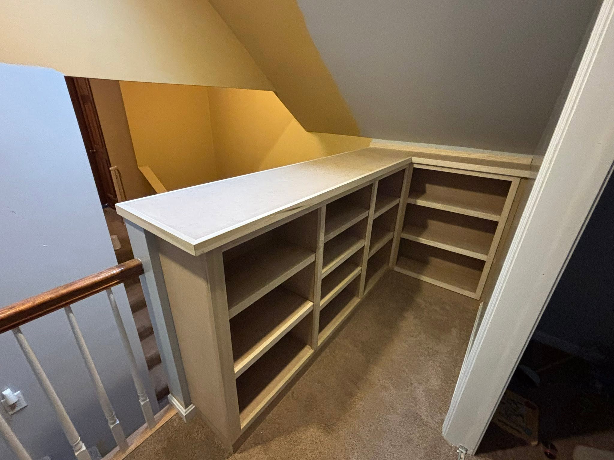 Custom woodwork by Handy Lou's — after — finished white painted built-in with shelves and cabinets