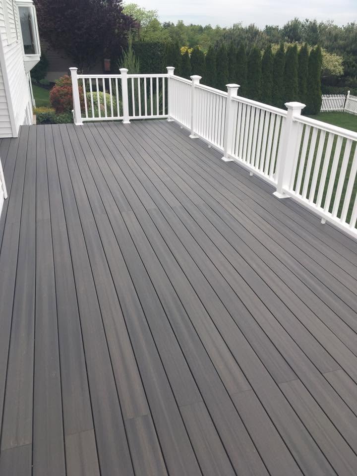 Deck or porch project by Handy Lou's — dark gray composite deck with white railings
