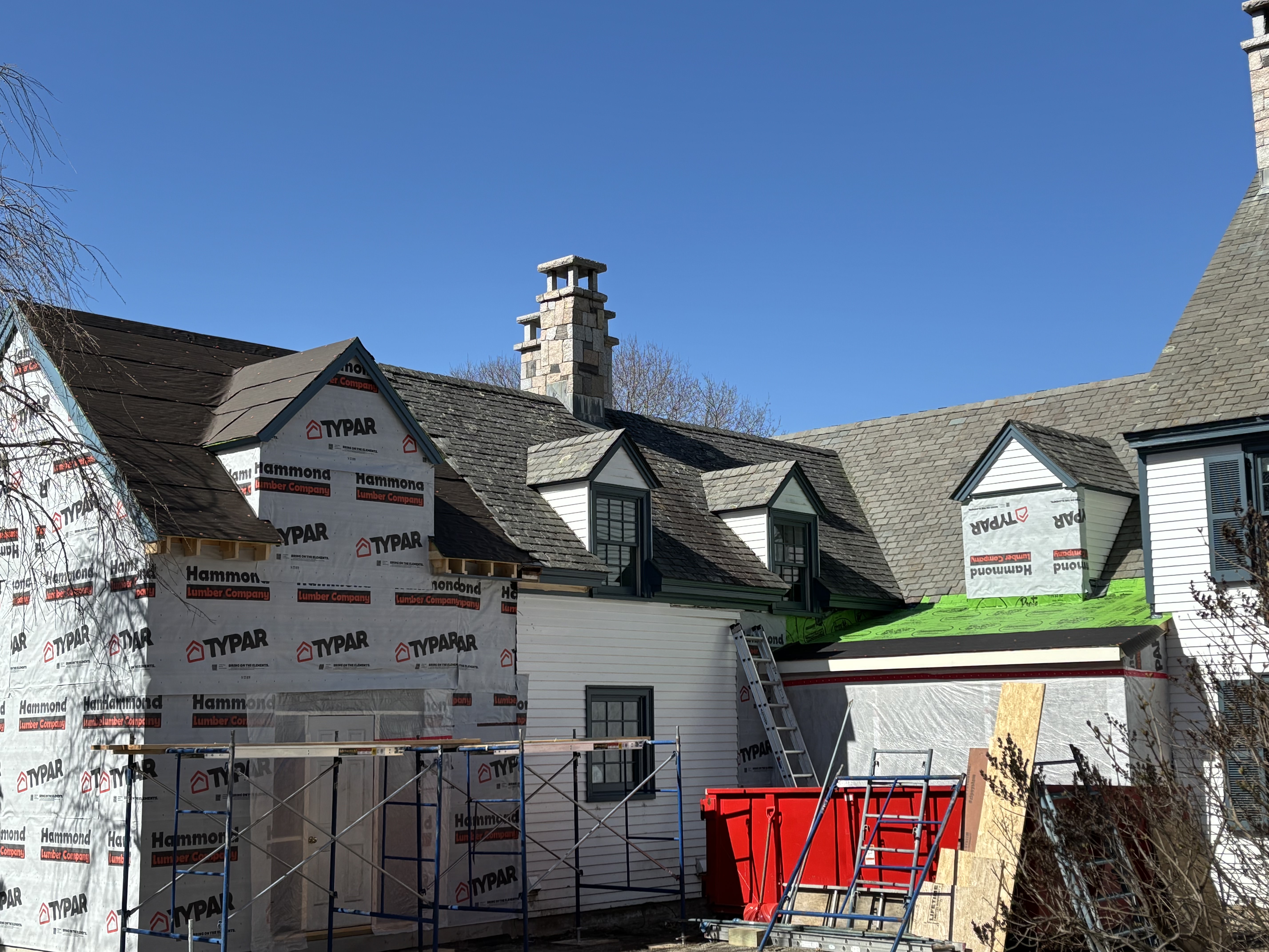 Multi-roof residential project with scaffolding and protection