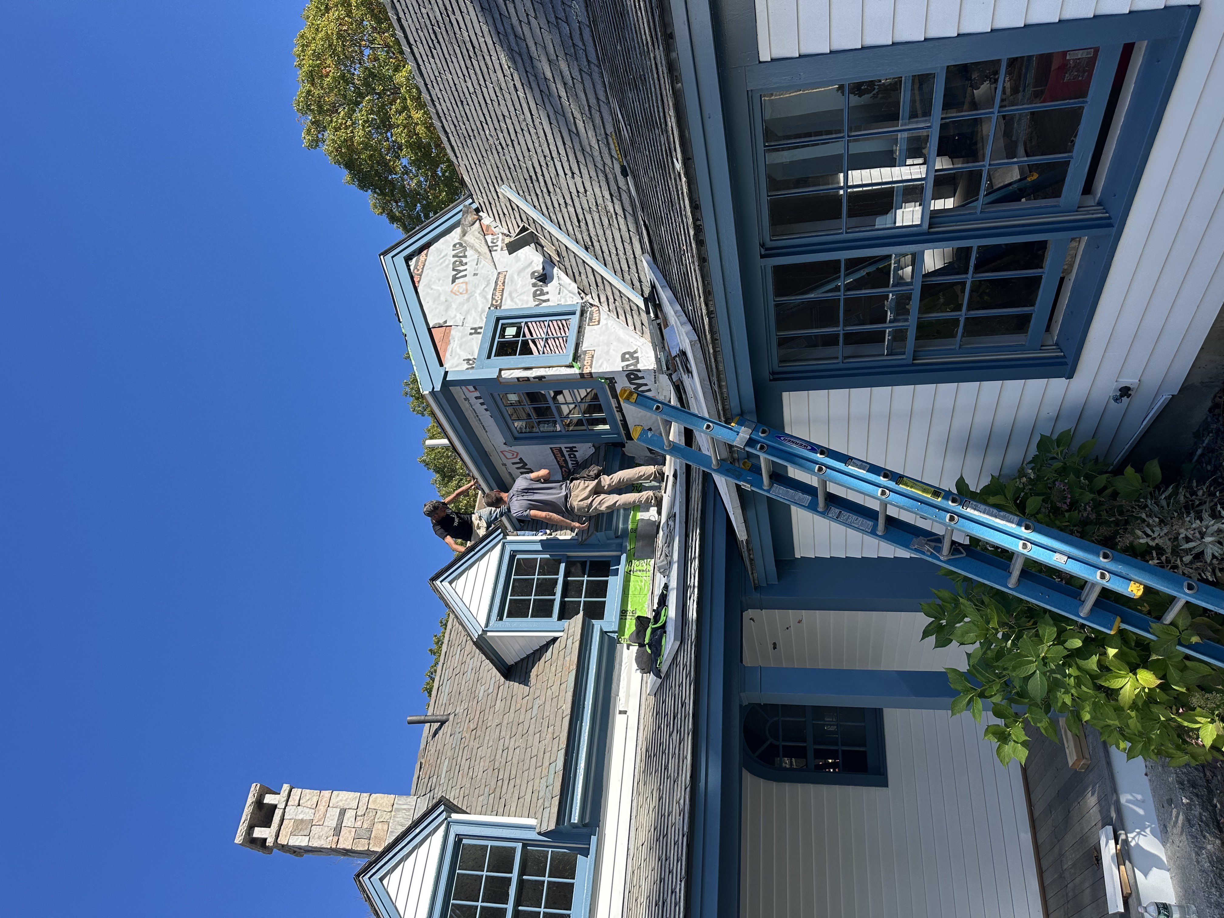 Slate roof detail showing natural gray slate pattern on steep pitch roof