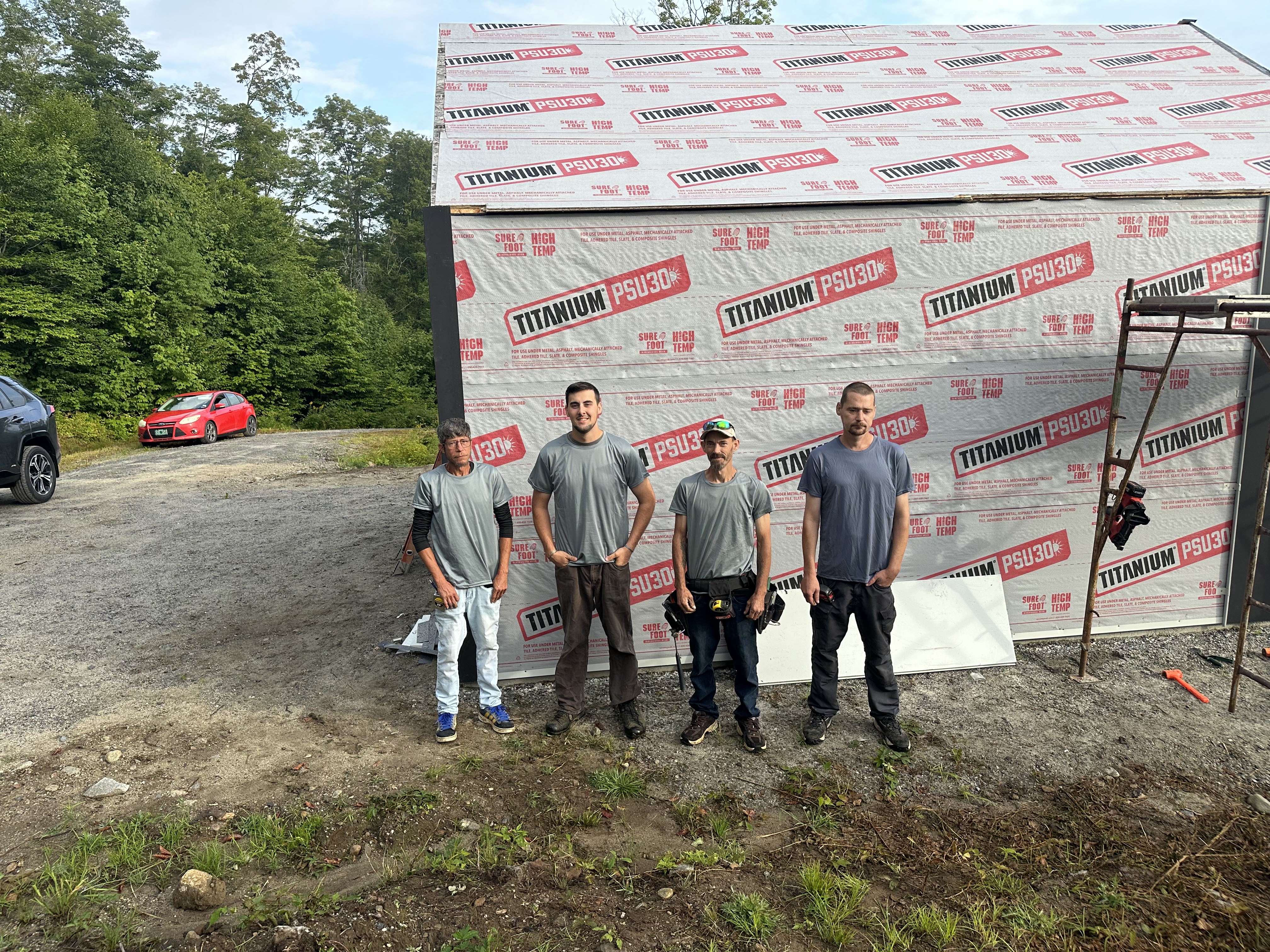 Heritage Slating crew standing together in front of roofing underlayment