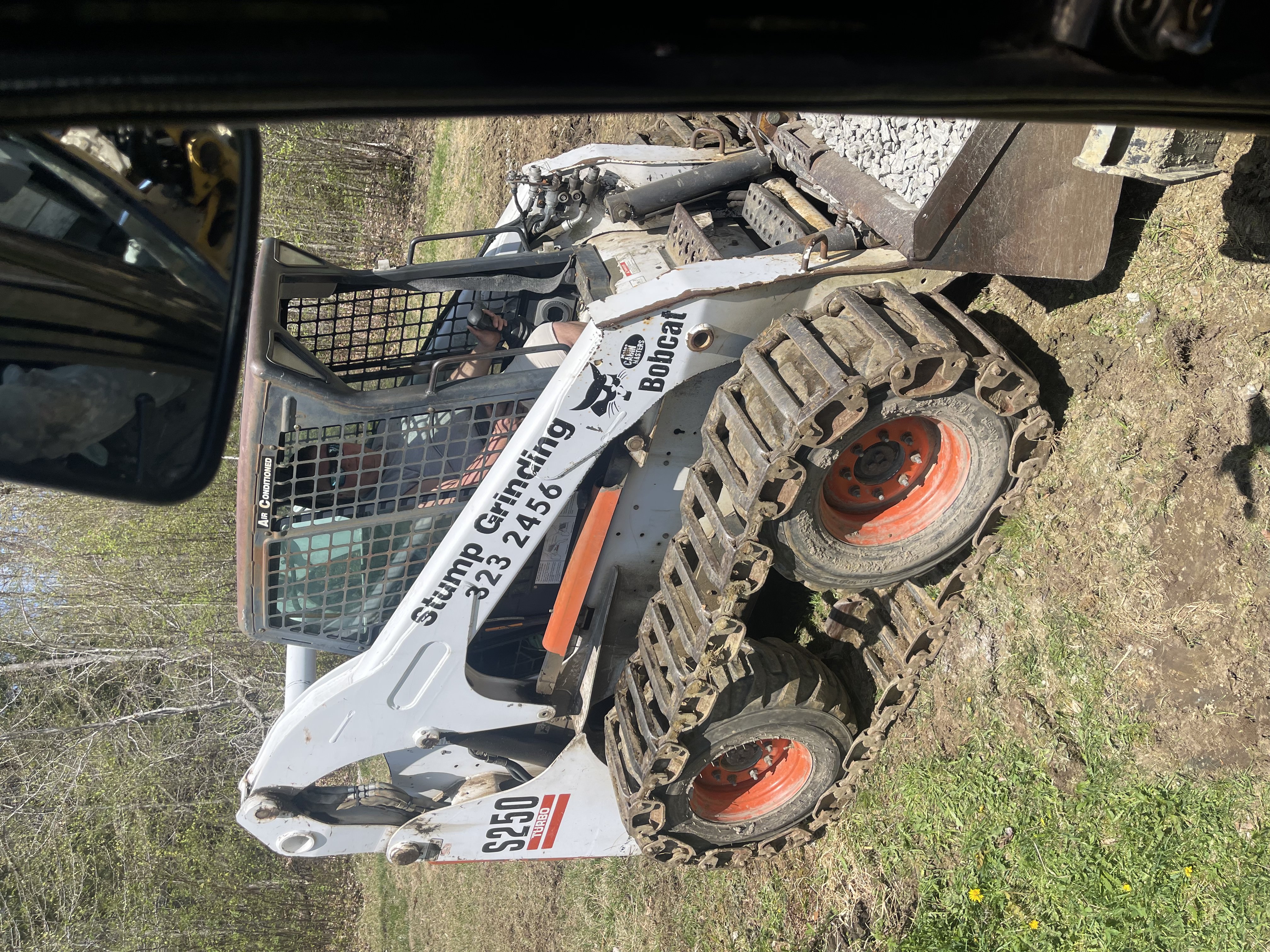 Heavy equipment and stump grinding machinery at residential job site