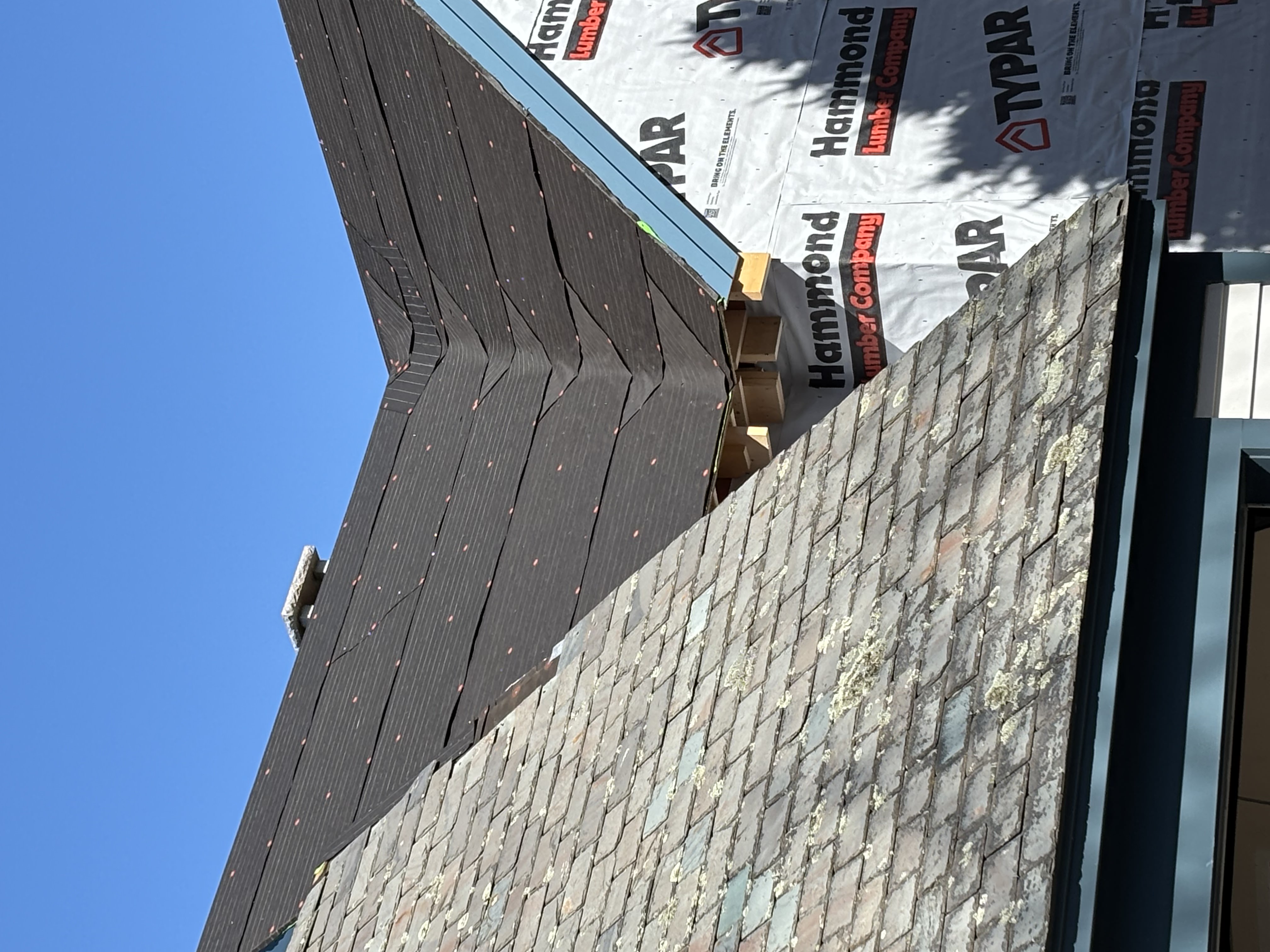 New slate installation with underlayment visible