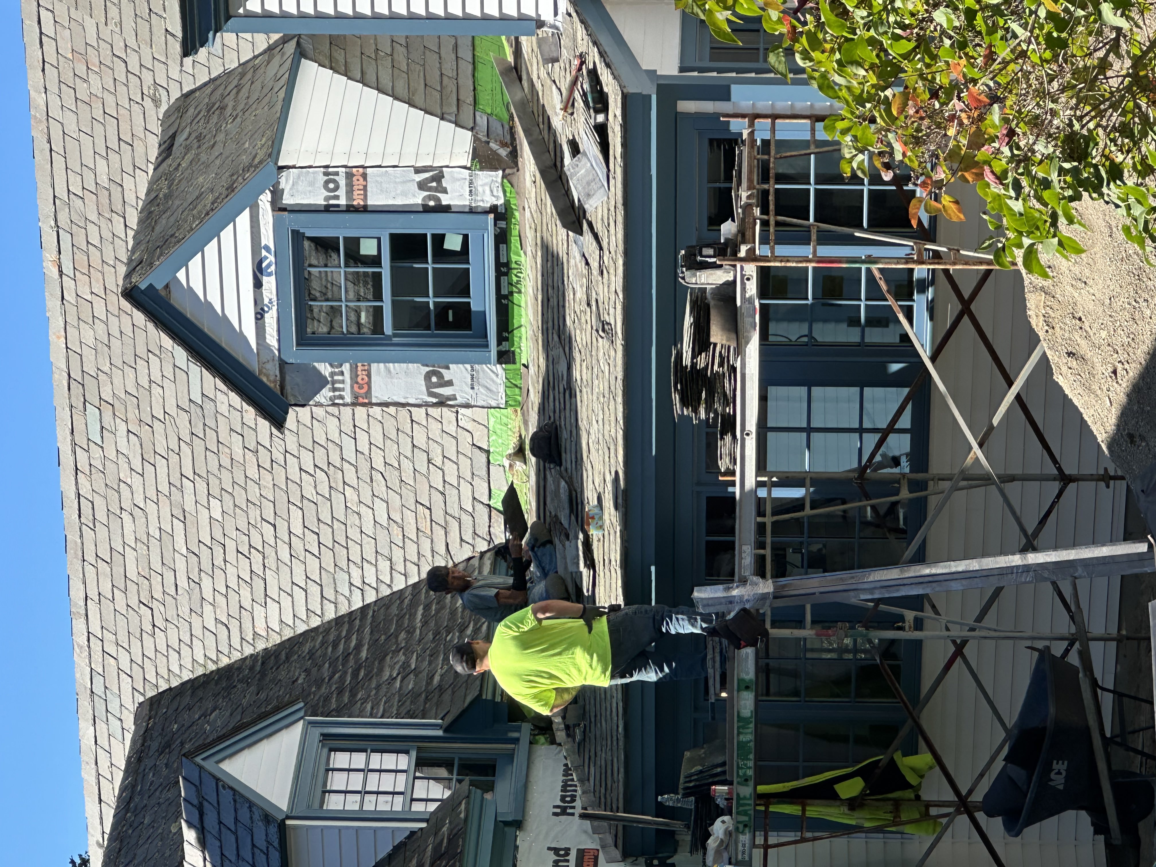 Slate roof installation in progress on Vermont home with scaffolding