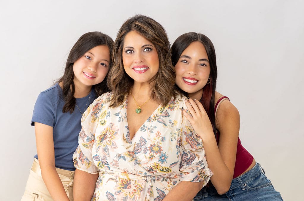 Mother with two daughters portrait by Brooke Lazzarini