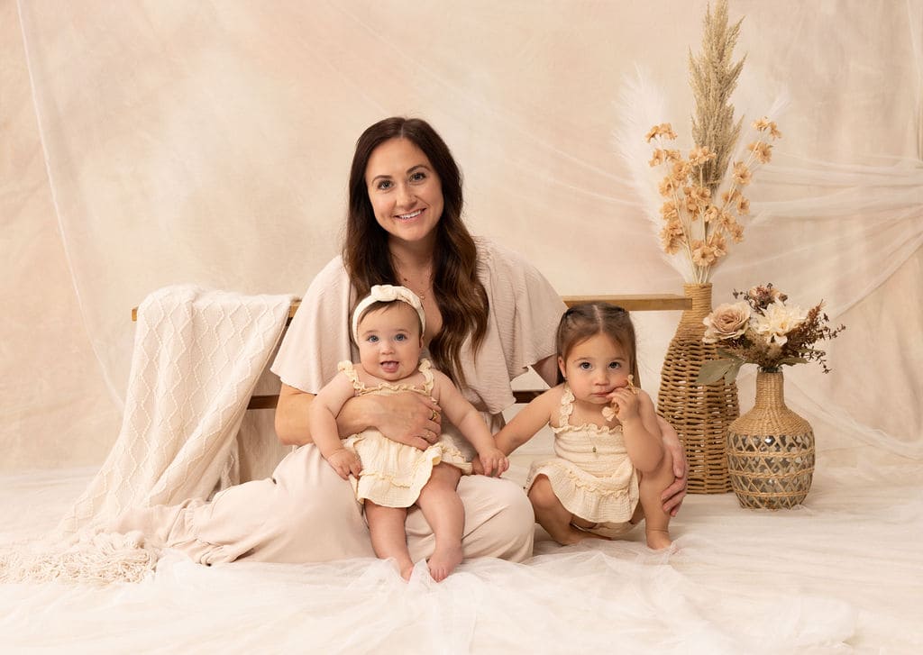Mother and two girls seated portrait by Brooke Lazzarini
