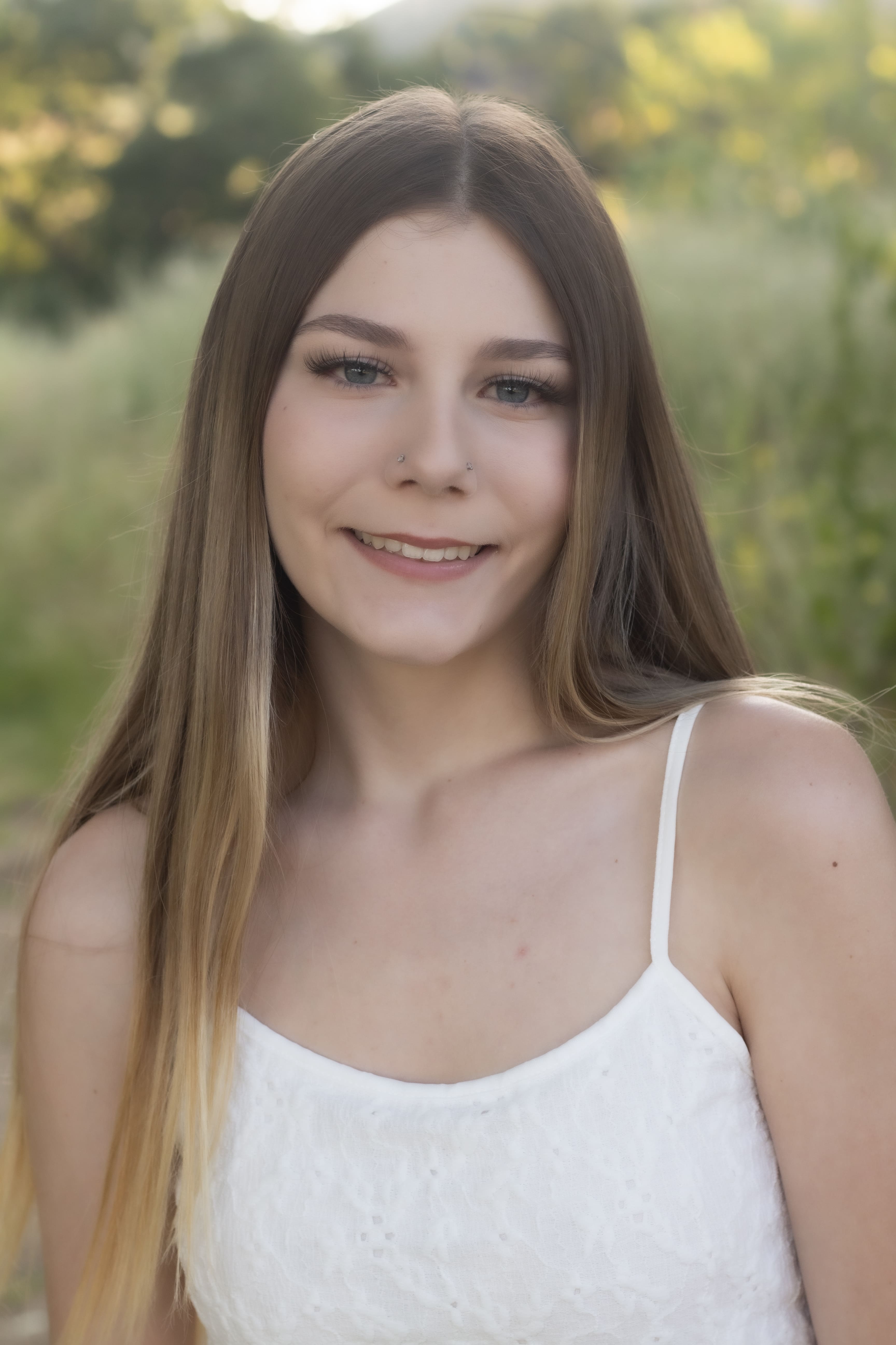Senior in white camisole smiling portrait by Brooke Lazzarini