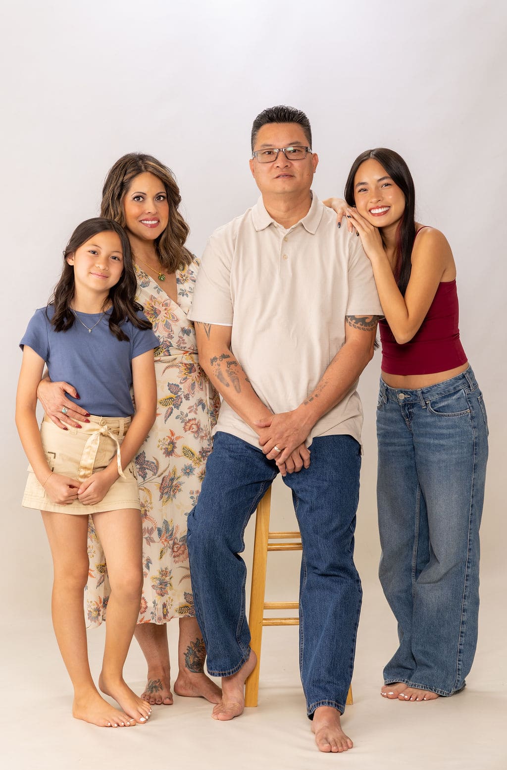 Family of four standing portrait by Brooke Lazzarini