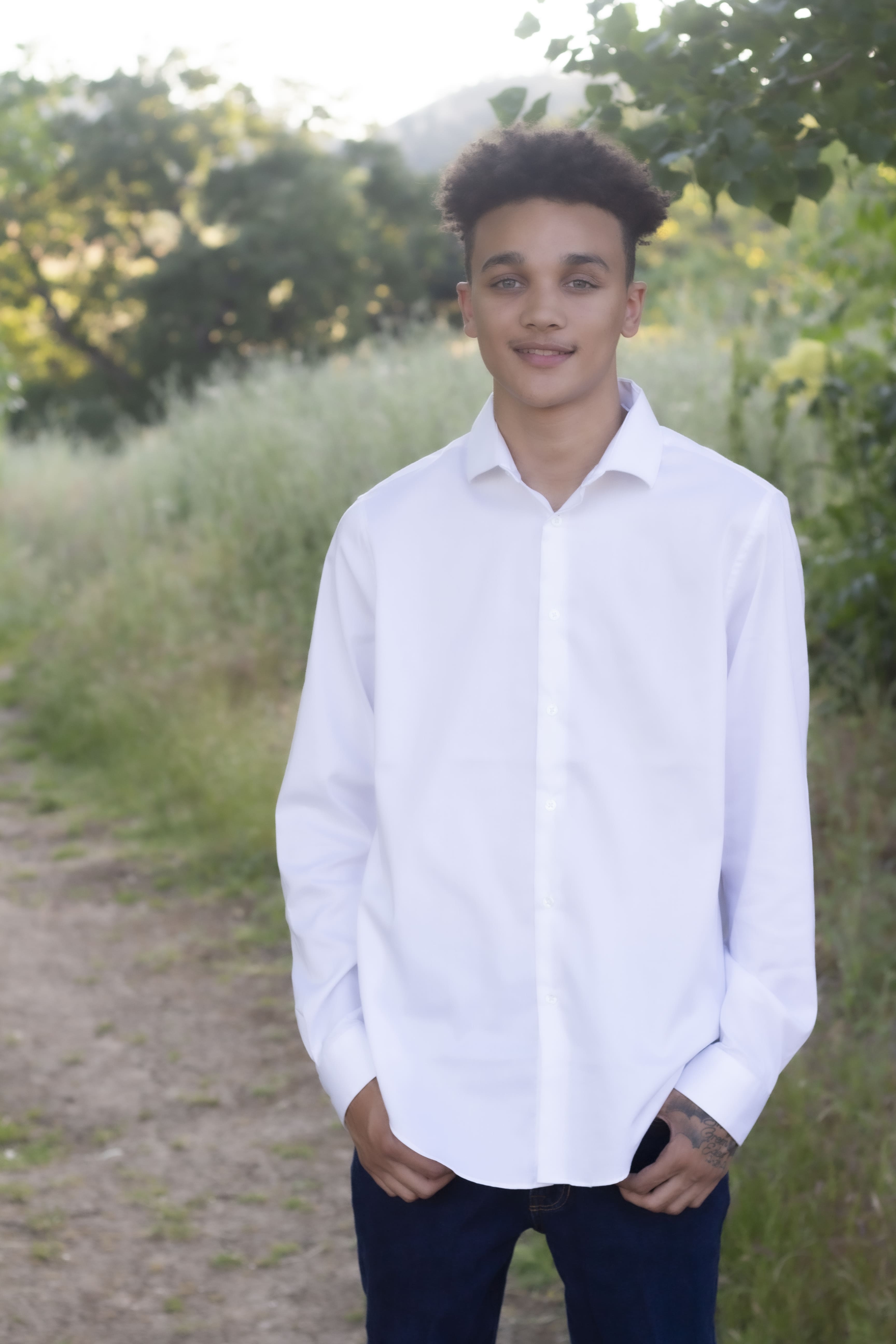 Senior in white button-down standing portrait by Brooke Lazzarini
