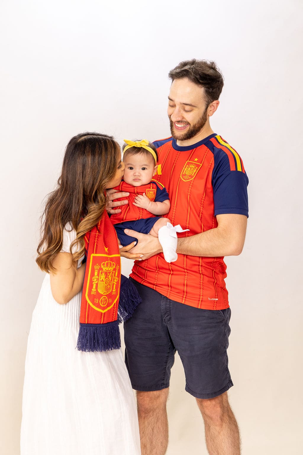 Family in Spain soccer jersey portrait by Brooke Lazzarini