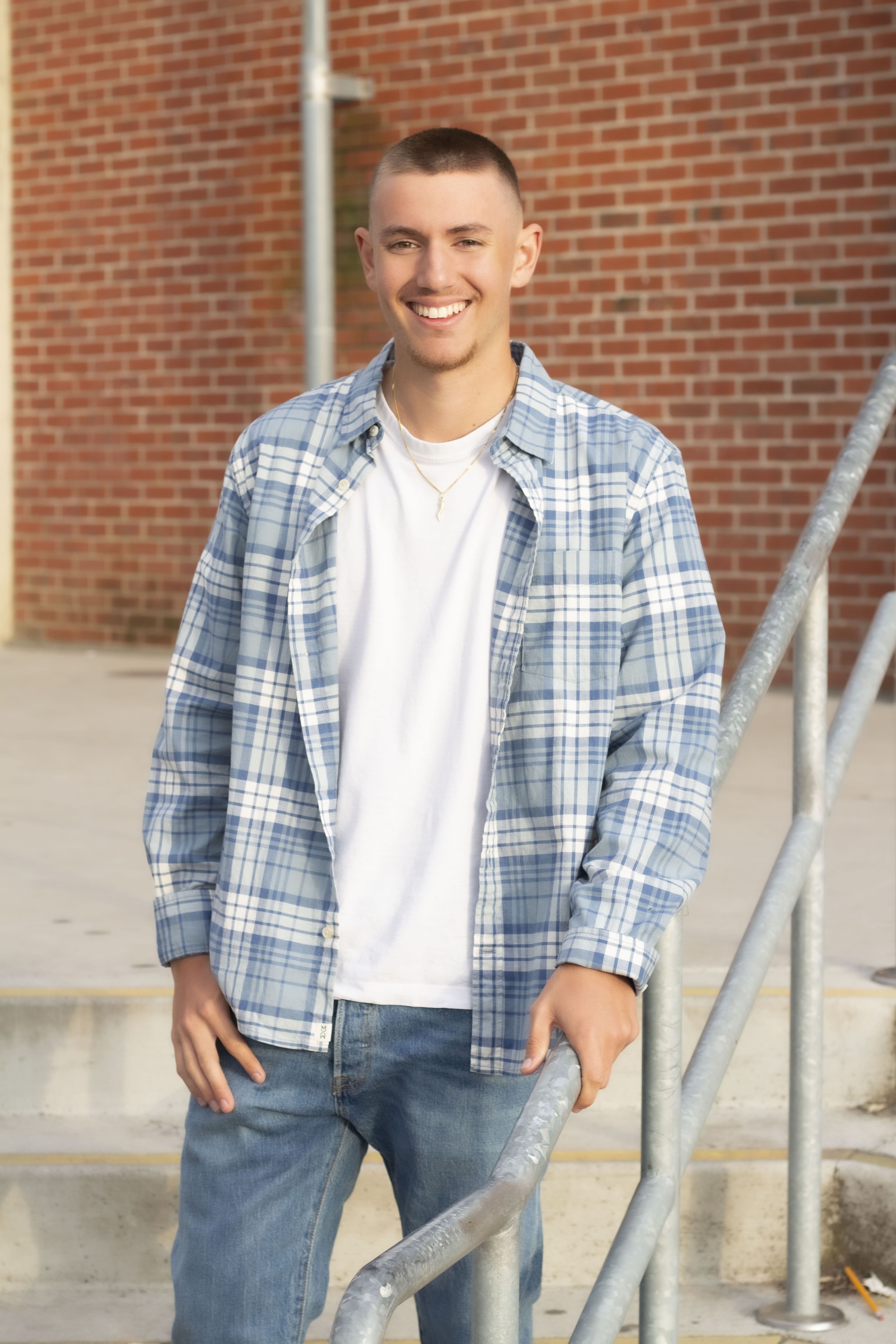 Senior smiling on stairs portrait by Brooke Lazzarini