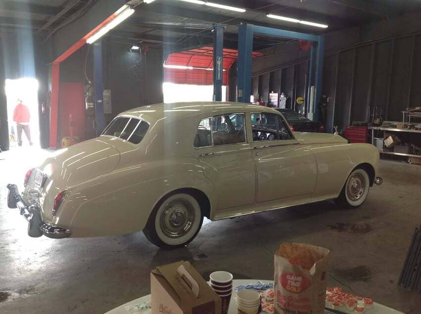 Vintage cream-colored classic car restoration project in our clean workshop