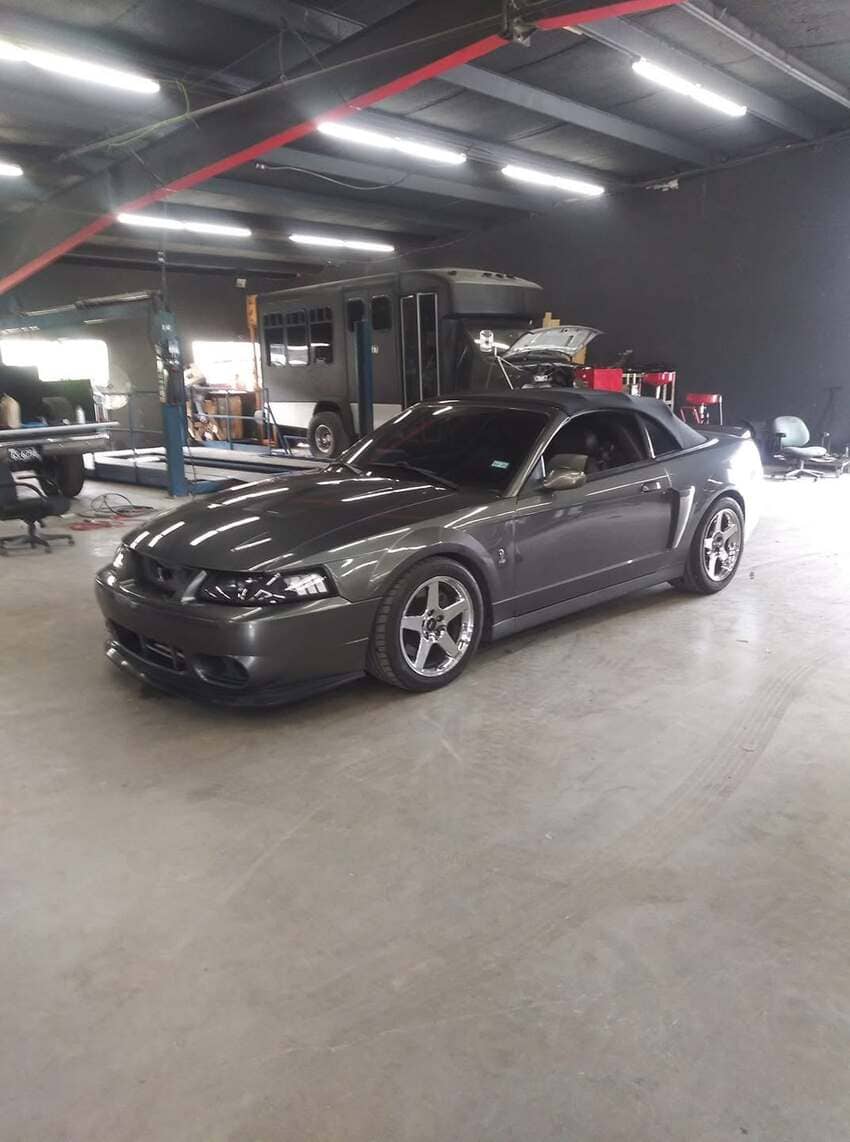Dark gray sports car ready for service in clean shop environment