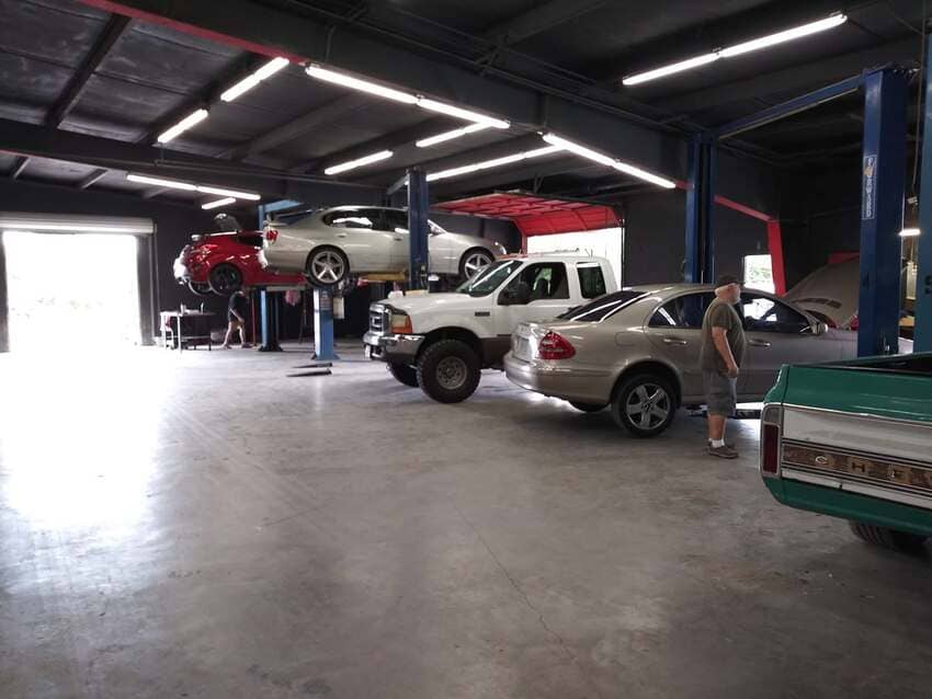 Full shop view with multiple vehicles on lifts at The Austin Diesel Specialists