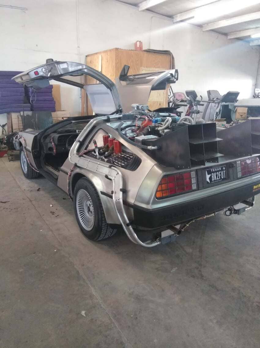 DeLorean time machine replica with gull-wing doors open in our workshop