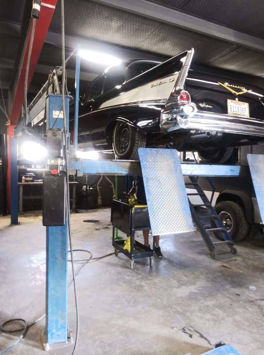 Classic Chevrolet Bel Air on lift receiving restoration work at our Austin shop